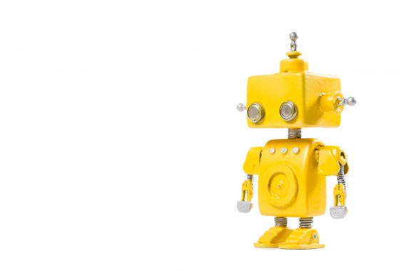 Cute, yellow, handmade robot on a white background.